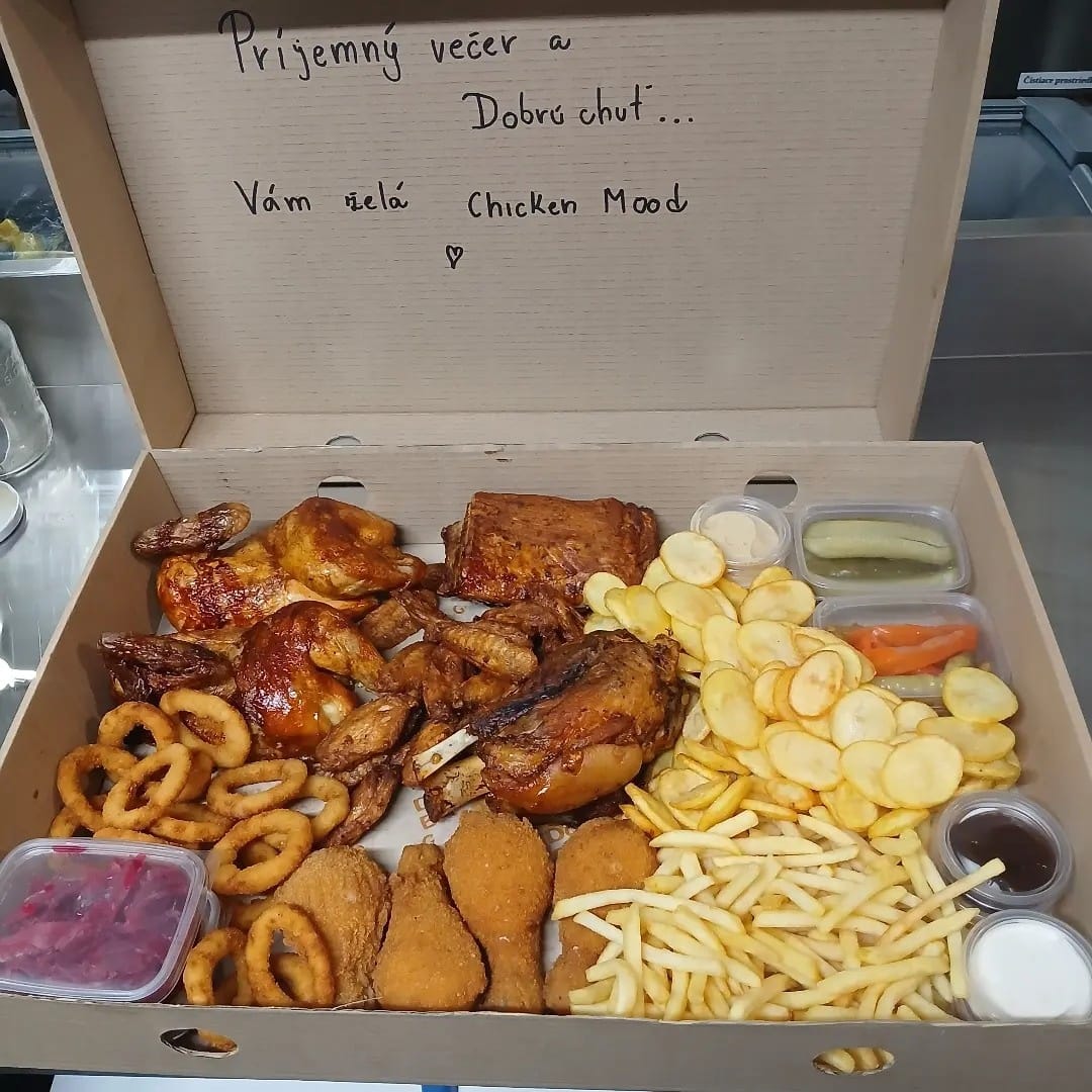 Otvorený box Chicken Mood s ručne písaným odkazom, vnútri grilované kurča, rebrá, krídla, obaľované stehná, hranolky a omáčky